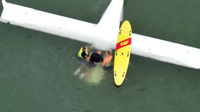 Rescuers pulling Finkelstein out of his plane.